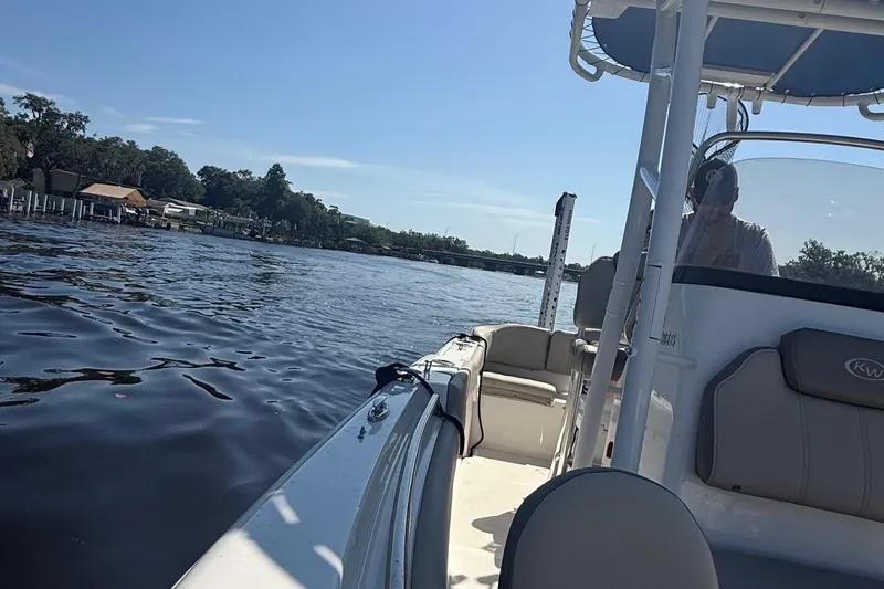 Slide: The Image of 2023 Key West 203 FS boat on a calm lake under a clear blue sky. - 9