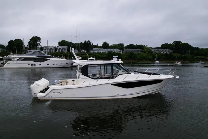 Slide: The Image of 2024 Boston Whaler 405 Conquest boat on calm water, surrounded by other vessels. - 15