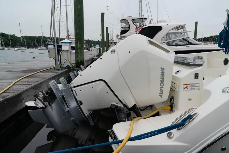 Slide: The Image of 2024 Boston Whaler 405 Conquest with Mercury outboard engine docked at marina. - 18