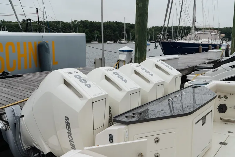 Slide: The Image of 2024 Boston Whaler 405 Conquest with quad Mercury 400 engines docked at marina. - 19