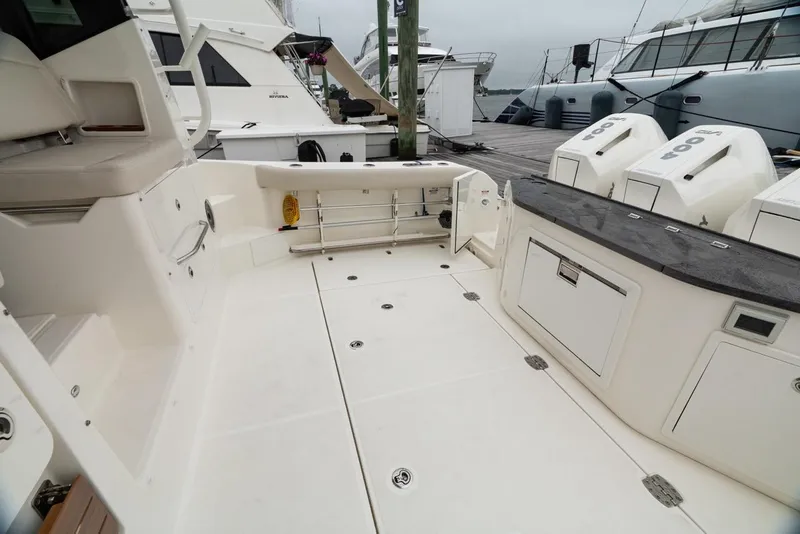 Slide: The Image of 2024 Boston Whaler 405 Conquest boat deck with outboard engines and storage compartments. - 23
