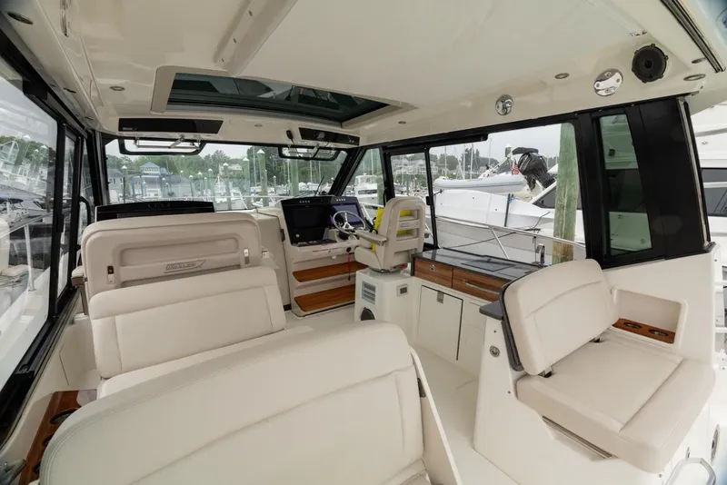 Slide: The Image of 2024 Boston Whaler 405 Conquest interior with luxurious seating and modern helm. - 27