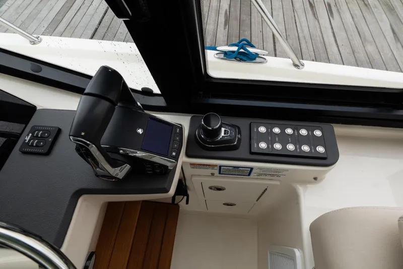 Slide: The Image of 2024 Boston Whaler 405 Conquest helm controls with joystick and display. - 39