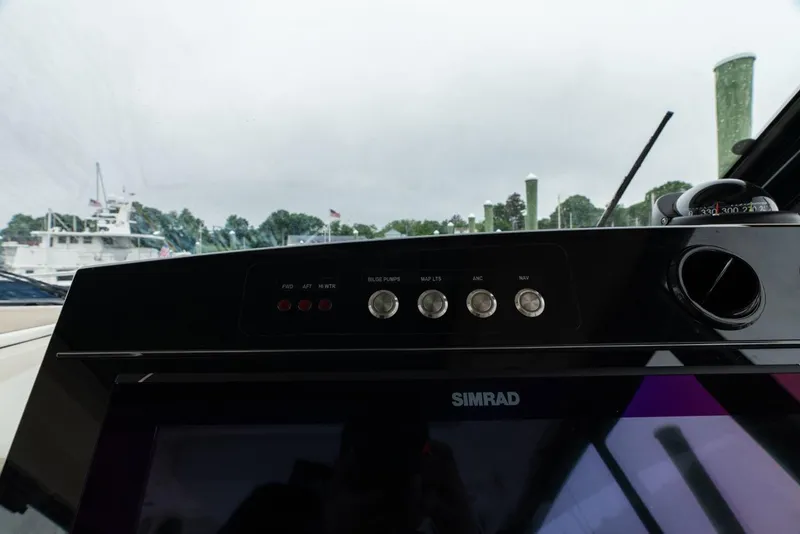 Slide: The Image of Control panel of 2024 Boston Whaler 405 Conquest with Simrad display and switches. - 42