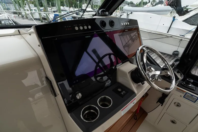 Slide: The Image of Helm of 2024 Boston Whaler 405 Conquest with modern controls and steering wheel. - 43