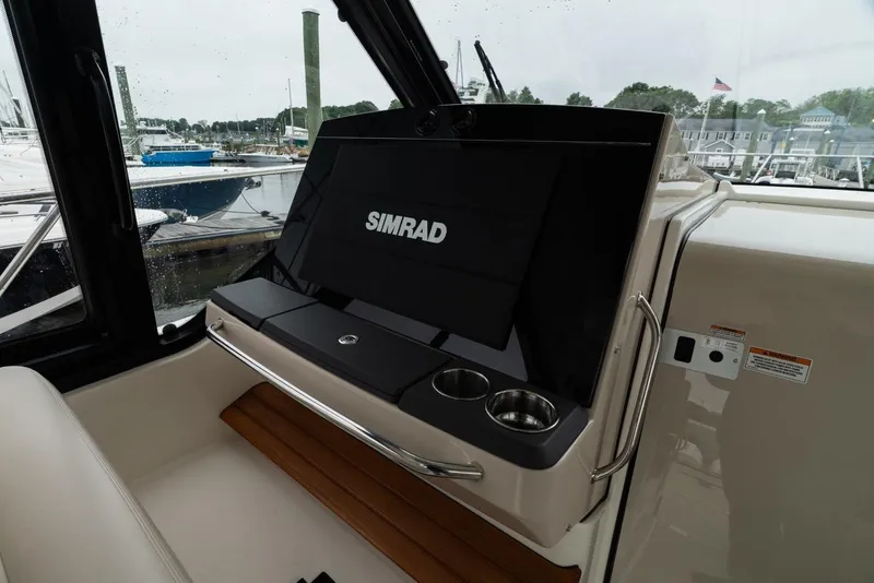 Slide: The Image of 2024 Boston Whaler 405 Conquest helm with Simrad display and cup holders. - 44