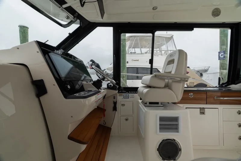 Slide: The Image of 2024 Boston Whaler 405 Conquest helm with modern controls and comfortable seating. - 45