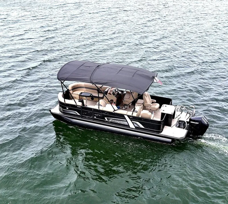 The Image of 2025 Smoker Craft EXS-3 FD pontoon boat cruising on open water. - 0