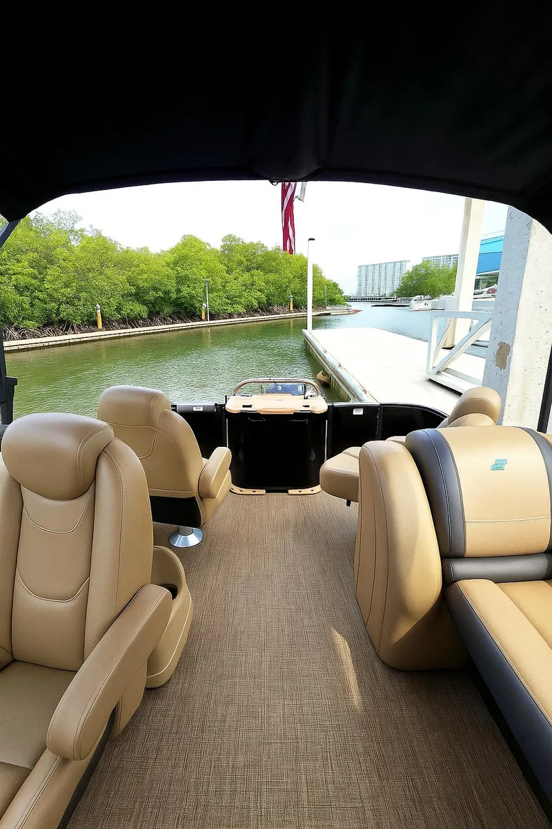Slide: The Image of 2025 Smoker Craft EXS-3 FD boat interior with tan seating and water view. - 5