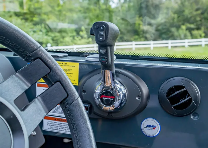 Slide: The Image of 2023 XO Boats EXPLR 9 dashboard with steering wheel and throttle control. - 10