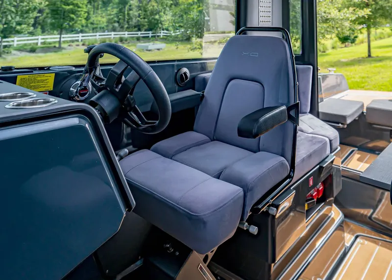 Slide: The Image of 2023 XO Boats EXPLR 9 interior with steering wheel and comfortable seating. - 11