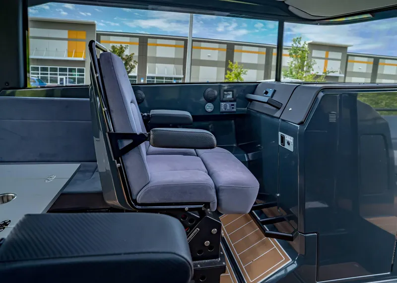 Slide: The Image of Interior of 2023 XO Boats EXPLR 9, featuring modern seating and control panel. - 13