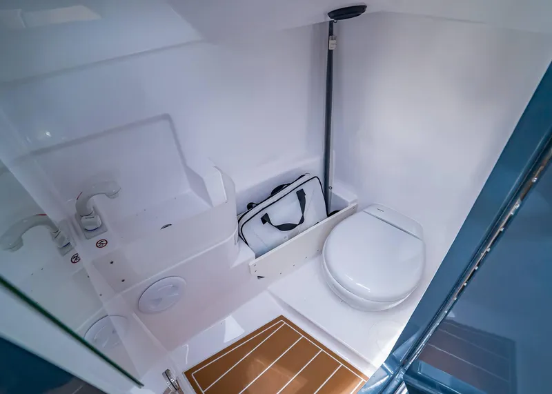 Slide: The Image of 2023 XO Boats EXPLR 9 interior bathroom with toilet and sink. - 16