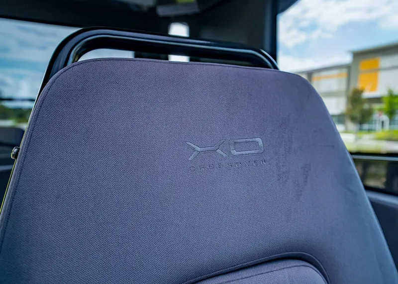 Slide: The Image of 2023 XO Boats EXPLR 9 seat with embossed logo, showcasing luxury design. - 19