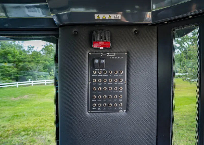 Slide: The Image of Control panel of 2023 XO Boats EXPLR 9, featuring multiple switches and indicators. - 20