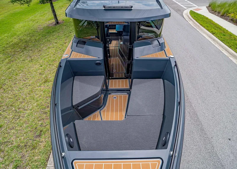 Slide: The Image of 2023 XO Boats EXPLR 9 with sleek design and spacious seating on a road. - 21