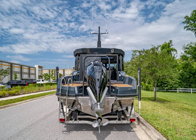 Slide: The Image of 2023 XO Boats EXPLR 9 on trailer, rear view, parked on a sunny day. - 3