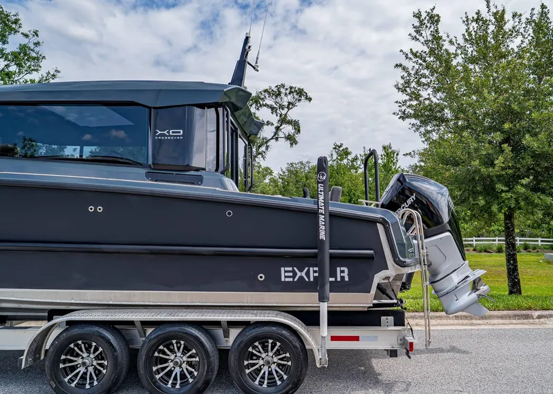 Slide: The Image of 2023 XO Boats EXPLR 9 on trailer, sleek design, parked outdoors. - 4