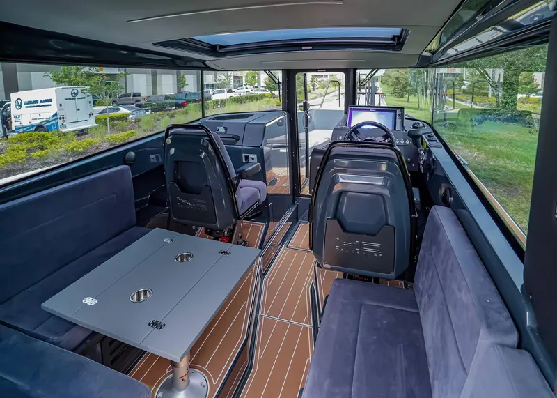 Slide: The Image of Interior of 2023 XO Boats EXPLR 9, featuring modern seating and navigation area. - 7