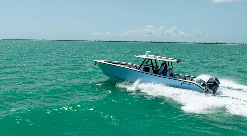 Slide: The Image of 2022 Yellowfin 39 boat cruising on turquoise ocean waters. - 16
