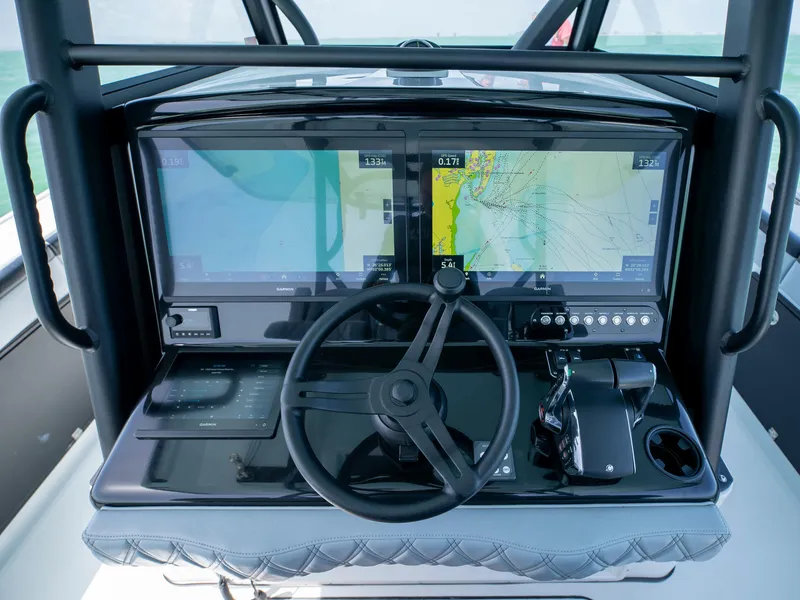 Slide: The Image of Cockpit of 2022 Yellowfin 39 boat with dual navigation screens and steering wheel. - 18