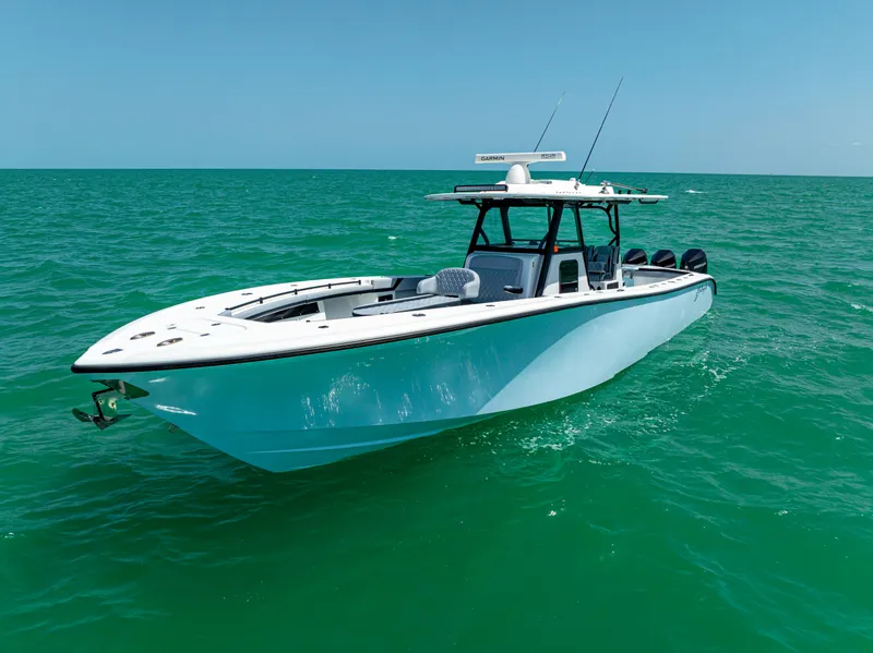 Slide: The Image of 2022 Yellowfin 39 boat cruising on clear turquoise waters under a bright blue sky. - 2
