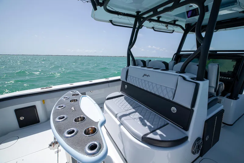 Slide: The Image of 2022 Yellowfin 39 boat interior with seating and rod holders on open water. - 21