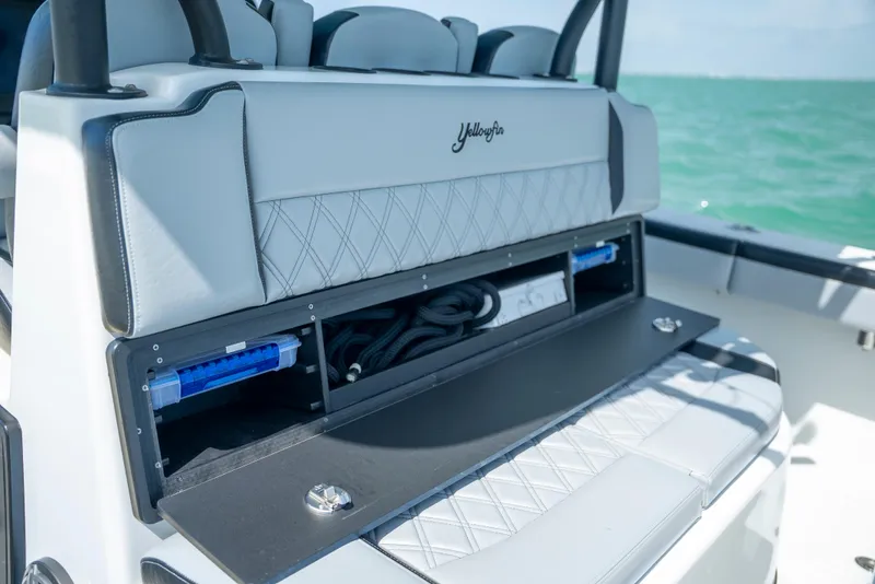 Slide: The Image of 2022 Yellowfin 39 boat interior with storage compartment open, showcasing sleek design. - 28