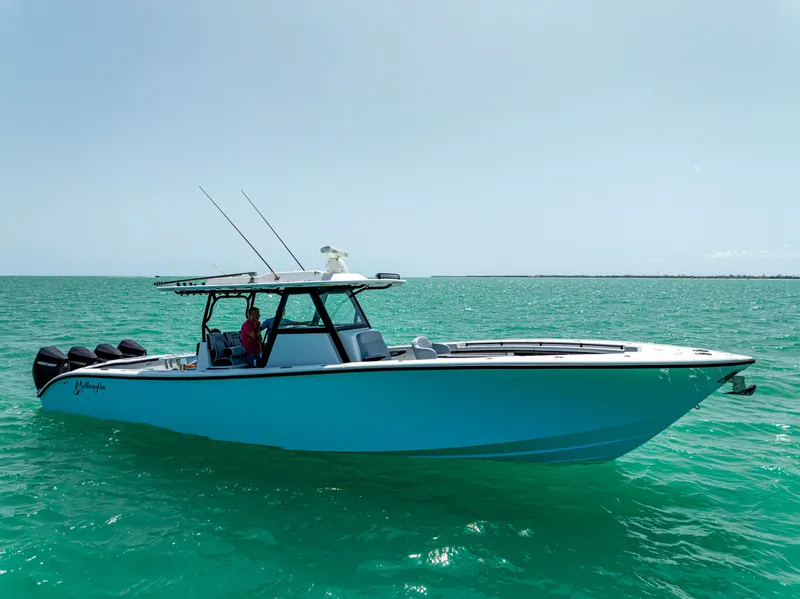 Slide: The Image of 2022 Yellowfin 39 boat on turquoise water, clear sky background. - 3