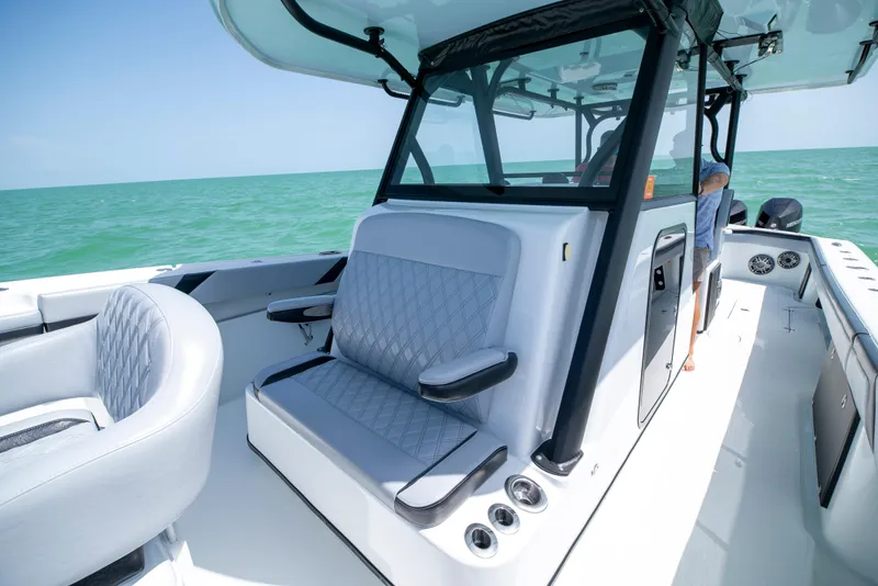 Slide: The Image of 2022 Yellowfin 39 boat interior with cushioned seating and ocean view. - 37
