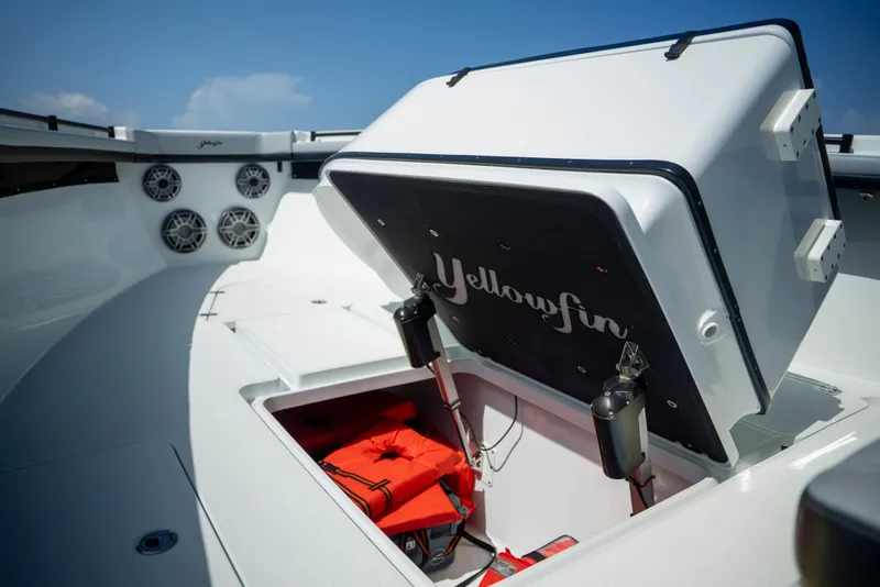 Slide: The Image of 2022 Yellowfin 39 boat with open storage compartment and life jackets. - 39