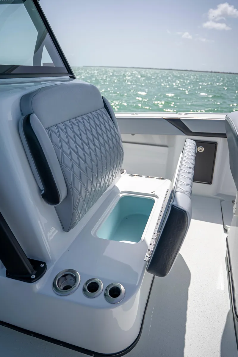 Slide: The Image of 2022 Yellowfin 39 boat interior with cushioned seating and ocean view. - 43