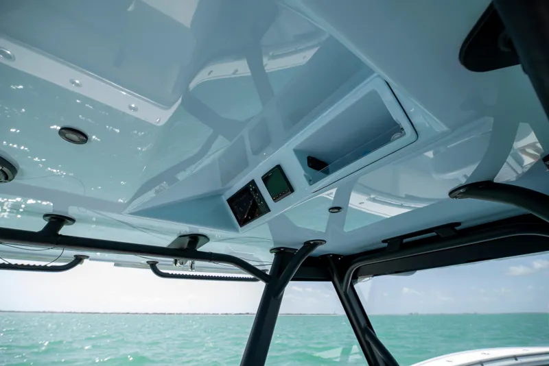 Slide: The Image of 2022 Yellowfin 39 boat interior, featuring sleek design and modern controls against a sea backdrop. - 49
