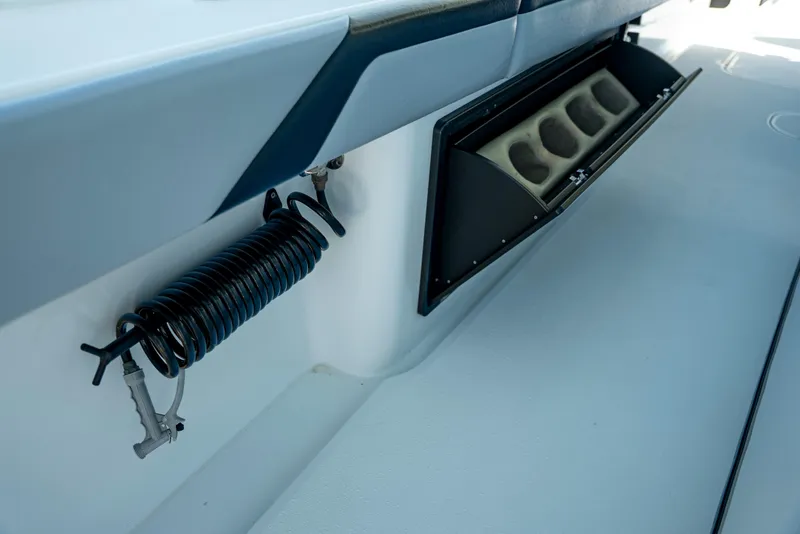 Slide: The Image of 2022 Yellowfin 39 boat interior with coiled hose and storage compartment. - 51