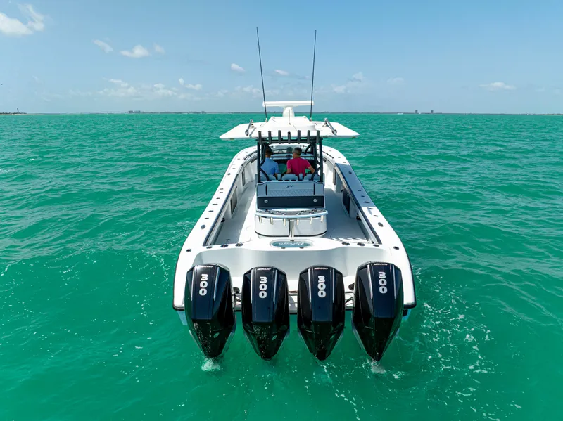 Slide: The Image of 2022 Yellowfin 39 boat with four engines on turquoise water. - 7