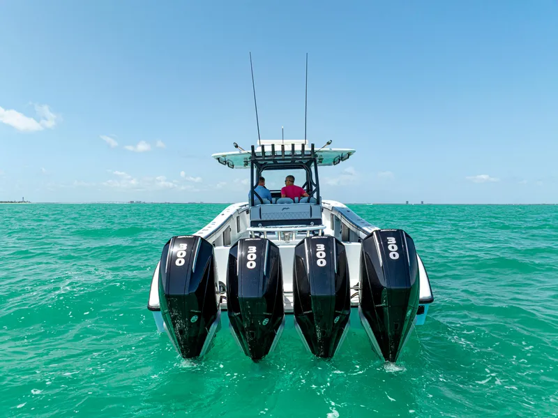 Slide: The Image of 2022 Yellowfin 39 boat with four powerful engines on turquoise water. - 8
