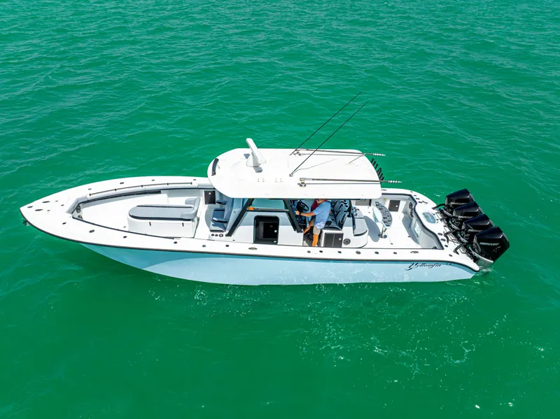 Slide: The Image of 2022 Yellowfin 39 boat cruising on clear turquoise water. - 9