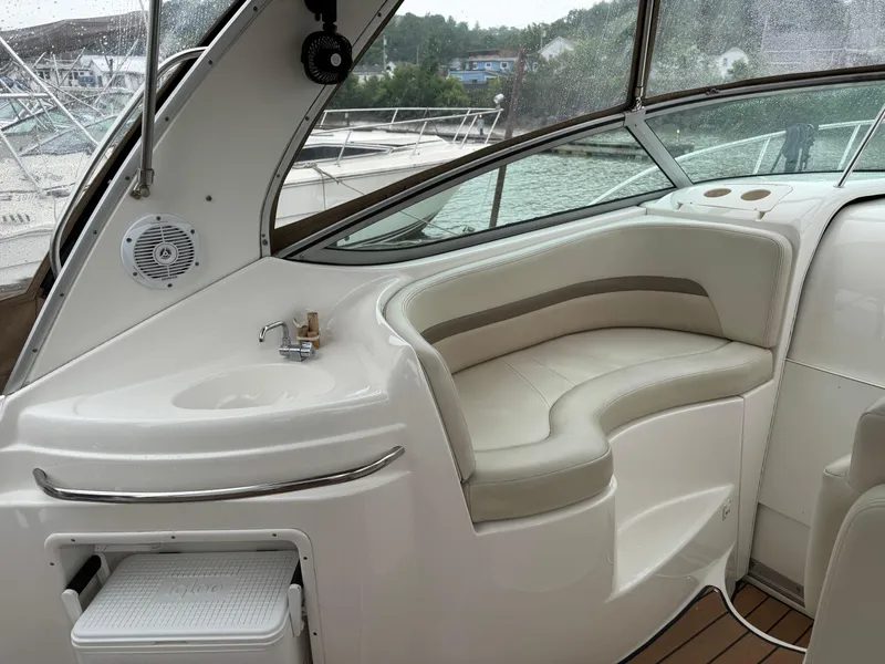 Slide: The Image of 2004 Chaparral 290 Signature boat interior with seating and sink, featuring sleek design. - 10