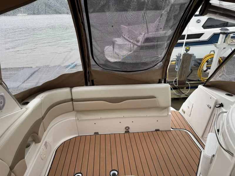 Slide: The Image of 2004 Chaparral 290 Signature boat interior with cushioned seating and wood flooring. - 13