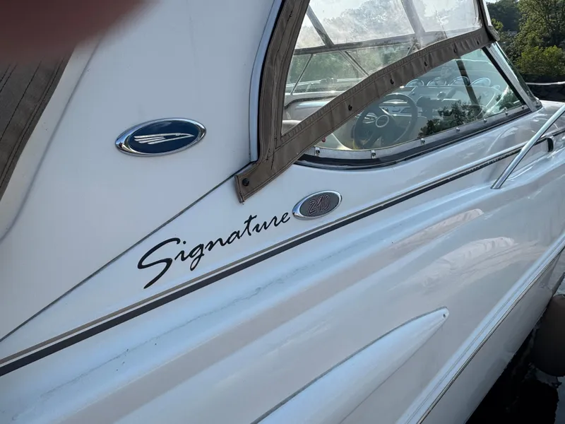 Slide: The Image of 2004 Chaparral 290 Signature boat, white exterior with "Signature" logo, partial view of cockpit. - 2