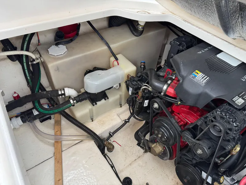 Slide: The Image of Engine compartment of a 2004 Chaparral 290 Signature boat, showcasing mechanical components. - 24