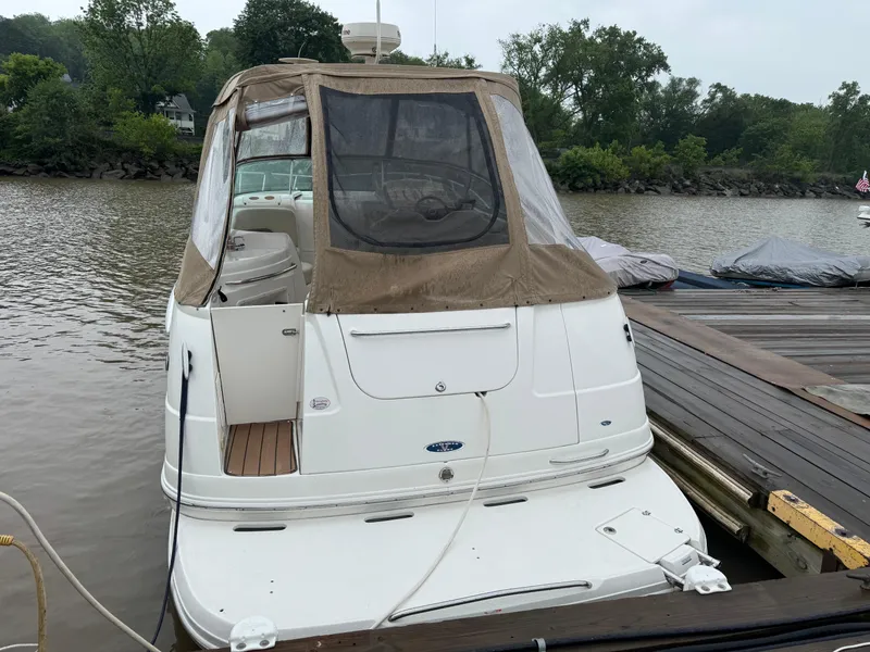 Slide: The Image of 2004 Chaparral 290 Signature boat docked on a calm river with lush greenery. - 4