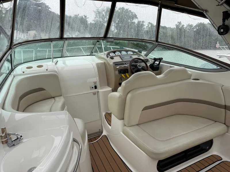 Slide: The Image of 2004 Chaparral 290 Signature boat interior with beige seating and wooden flooring. - 7