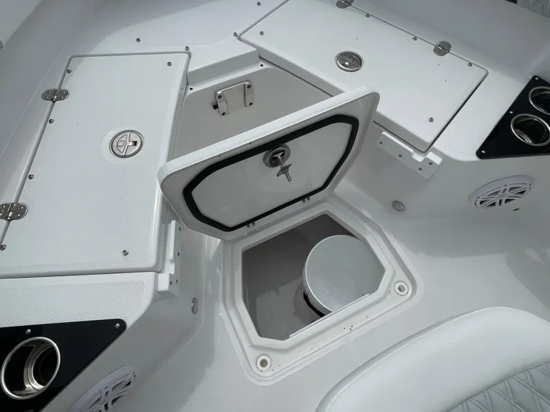 Slide: The Image of 2026 Blackfin 222CC boat interior with storage compartments and cup holders. - 10