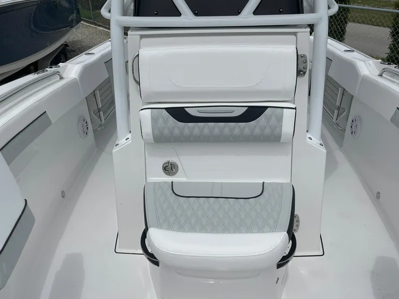 Slide: The Image of 2026 Blackfin 222CC boat interior with white cushioned seating and sleek design. - 13