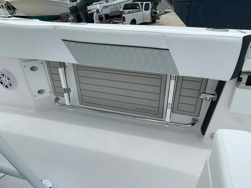 Slide: The Image of 2026 Blackfin 222CC boat interior with sleek seating and storage compartment. - 23