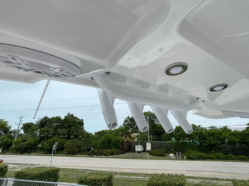Slide: The Image of 2026 Blackfin 222CC boat with rod holders and sleek design, viewed from below. - 27