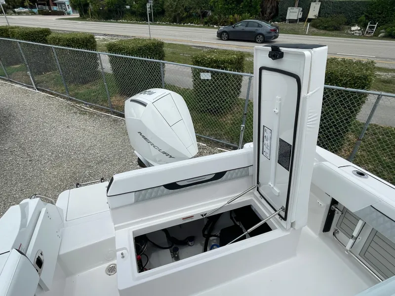 Slide: The Image of 2026 Blackfin 222CC boat with open storage compartment and visible outboard motor. - 29