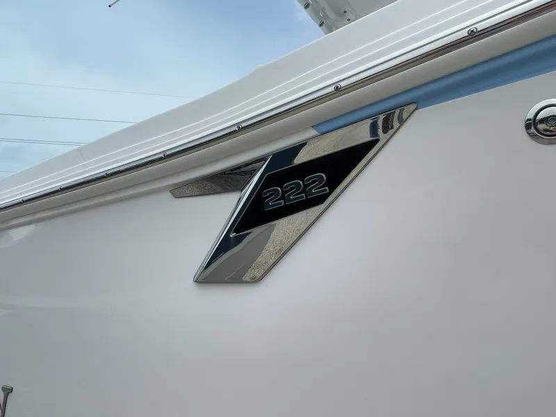 Slide: The Image of 2026 Blackfin 222CC boat emblem on sleek white exterior. - 3