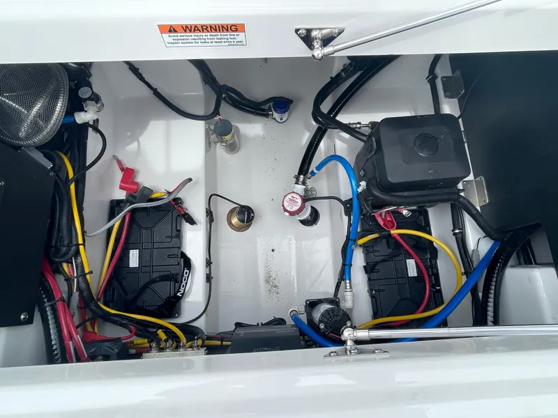 Slide: The Image of 2026 Blackfin 222CC boat battery compartment with wiring and components. - 30